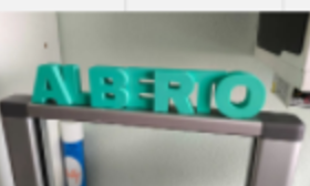 Teal 3D-printed standing name sign reading Alberio